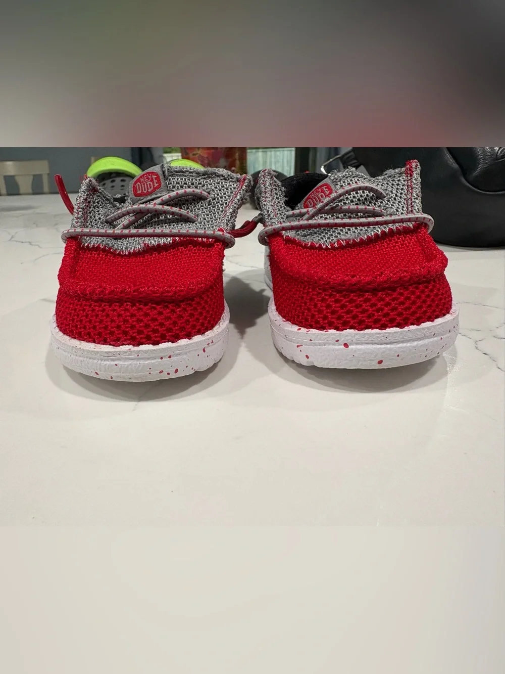 Hey Dude Kids Red and Gray Slip-On shoes.